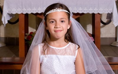 A young girl prepared to receive her First Communion.