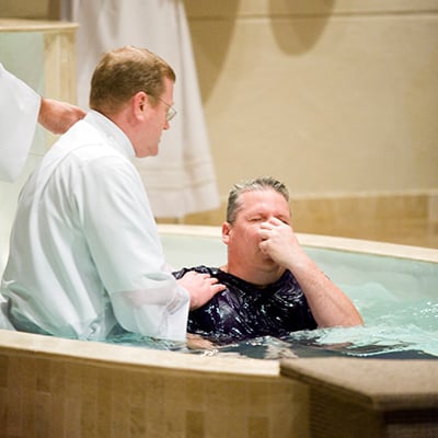 A candidate is baptized during the Easter Vigil Mass.