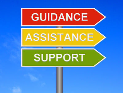 A signpost with the words: Guidance, Assistance and Support