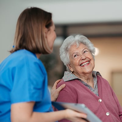 A Society of St. Vincent de Paul representative advises an elderly woman.